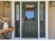 Elegant dark green front door with sidelights and decorative glass at 1914 24Th W Ave, Palmetto, FL 34221