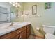 Well-lit bathroom with a large vanity, toilet and shower at 1914 24Th W Ave, Palmetto, FL 34221