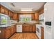 Bright kitchen featuring wood cabinets, granite countertops, and a large window at 1914 24Th W Ave, Palmetto, FL 34221