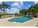 Inviting pool area with patio furniture, lush landscaping, and a spa at 1914 24Th W Ave, Palmetto, FL 34221