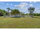 Backyard oasis with a pool, white fence, and palm trees at 1914 24Th W Ave, Palmetto, FL 34221