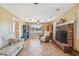 Cozy living room with a brick fireplace and tiled floors at 1914 24Th W Ave, Palmetto, FL 34221