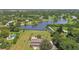 Aerial view of house on a lake with a pool and lush landscaping at 1914 24Th W Ave, Palmetto, FL 34221