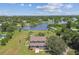 Aerial view of house on a lake, with lush green lawn and a swimming pool at 1914 24Th W Ave, Palmetto, FL 34221