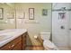 Clean bathroom featuring a shower, toilet and vanity with storage at 1914 24Th W Ave, Palmetto, FL 34221