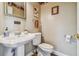 Small bathroom with pedestal sink, toilet, and decorative accents at 1914 24Th W Ave, Palmetto, FL 34221