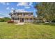 Two-story house with large front yard, porch, and mature trees at 1914 24Th W Ave, Palmetto, FL 34221