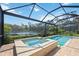Relax in the screened pool and spa with a view of the peaceful lake at 1048 Bradberry Dr, Nokomis, FL 34275