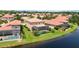 Aerial view of houses with pools, near a lake at 1048 Bradberry Dr, Nokomis, FL 34275