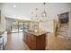 Island kitchen with granite countertops, stainless steel appliances, and sliding doors leading to a patio at 1048 Bradberry Dr, Nokomis, FL 34275