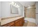 Bathroom boasts granite countertop, wood cabinets, and a bathtub at 1048 Bradberry Dr, Nokomis, FL 34275