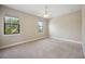 Well-lit bedroom featuring neutral walls and carpet flooring at 1048 Bradberry Dr, Nokomis, FL 34275