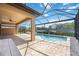 Spacious pool area with covered patio and tranquil lake view at 1048 Bradberry Dr, Nokomis, FL 34275