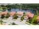 Aerial view of houses with red tile roofs, near a lake at 1048 Bradberry Dr, Nokomis, FL 34275