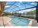 Relaxing pool and spa with screened enclosure overlooking a tranquil lake at 1048 Bradberry Dr, Nokomis, FL 34275