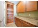 Walk-in pantry with wooden shelving and granite countertop at 1048 Bradberry Dr, Nokomis, FL 34275