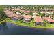 Aerial view of houses with pools, near a lake at 1048 Bradberry Dr, Nokomis, FL 34275