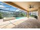Inviting pool and spa area with screened enclosure overlooking a lake at 1048 Bradberry Dr, Nokomis, FL 34275