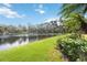 Serene backyard with lush landscaping and lake view at 1048 Bradberry Dr, Nokomis, FL 34275