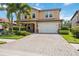 Two-story house with brick paver driveway and landscaping at 1048 Bradberry Dr, Nokomis, FL 34275