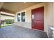 Welcoming front entry with red door and stone accents at 1048 Bradberry Dr, Nokomis, FL 34275