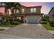 Two-story house with brick paver driveway and landscaping at 1048 Bradberry Dr, Nokomis, FL 34275