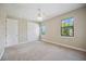 Well-lit bedroom with two windows, double doors, and carpeted floors at 1048 Bradberry Dr, Nokomis, FL 34275
