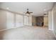 Spacious bonus room with neutral carpeting and wood accent wall at 1048 Bradberry Dr, Nokomis, FL 34275