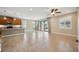 Open living room with tile floors, kitchen island view, and sliding glass doors at 1048 Bradberry Dr, Nokomis, FL 34275