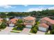 Aerial view of a house with red tile roof, near a lake at 1048 Bradberry Dr, Nokomis, FL 34275