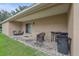 Covered back patio with wicker furniture and a view of the grassy backyard at 3362 Howell Pl, Sarasota, FL 34232