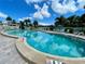 Relaxing kidney-shaped community pool with plenty of lounge chairs at 4480 Ironwood Cir # 305A, Bradenton, FL 34209