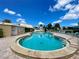 Community pool with lounge chairs and patio area at 4480 Ironwood Cir # 305A, Bradenton, FL 34209