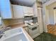 Efficient kitchen featuring white cabinets and an electric range at 4480 Ironwood Cir # 305A, Bradenton, FL 34209