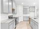 Modern kitchen with gray cabinets and granite countertops at 12665 Promenade Estates Blvd, Sarasota, FL 34238