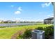 Spacious backyard overlooking a lake with community homes in the background at 12665 Promenade Estates Blvd, Sarasota, FL 34238