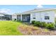 House exterior with screened patio overlooking the grass at 12665 Promenade Estates Blvd, Sarasota, FL 34238