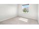 Bright bedroom with neutral carpeting and a large window at 12665 Promenade Estates Blvd, Sarasota, FL 34238