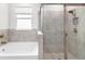 Bathroom featuring a soaking tub and a separate shower stall at 12665 Promenade Estates Blvd, Sarasota, FL 34238