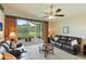 Relaxing living room offers comfortable seating, a view of the water, and access to a screened patio at 9861 50Th Street E Cir, Parrish, FL 34219