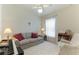 Relaxing bedroom with sofa, armchair, and ample natural light at 9861 50Th Street E Cir, Parrish, FL 34219