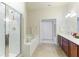 Spa-like bathroom with double vanity, soaking tub, and walk-in shower at 9861 50Th Street E Cir, Parrish, FL 34219