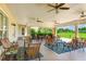 Relaxing covered patio with wicker furniture and ceiling fans at 9861 50Th Street E Cir, Parrish, FL 34219