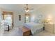 Large main bedroom with a king-size bed, plush carpet and ceiling fan at 9861 50Th Street E Cir, Parrish, FL 34219