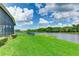 Expansive backyard with lush grass and lake view at 9861 50Th Street E Cir, Parrish, FL 34219