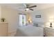 Comfortable guest bedroom with a queen-size bed and ceiling fan at 9861 50Th Street E Cir, Parrish, FL 34219