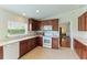 Kitchen with wood cabinets, tile floor and stainless steel appliances at 9861 50Th Street E Cir, Parrish, FL 34219