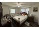 Bedroom with double bed, ceiling fan, and wood framed bed at 2712 Galleon Pl, Sarasota, FL 34235