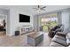 Living room with fireplace, TV, and sliding glass doors at 2508 Avolet Ct, Bradenton, FL 34211