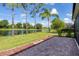 Backyard patio with brick pavers, lush green grass, and scenic views of the tranquil lake at 11492 Dancing River Dr, Venice, FL 34292